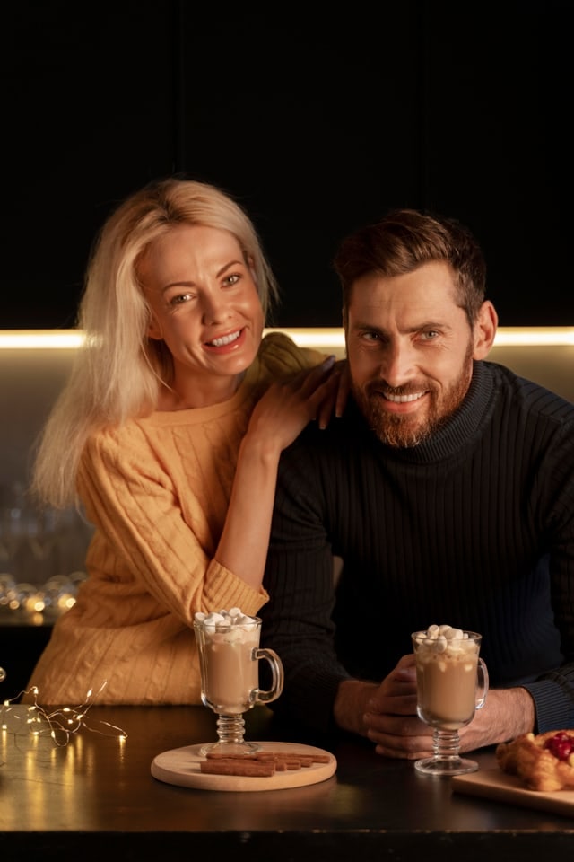 Couple smiling together over coffee at a table