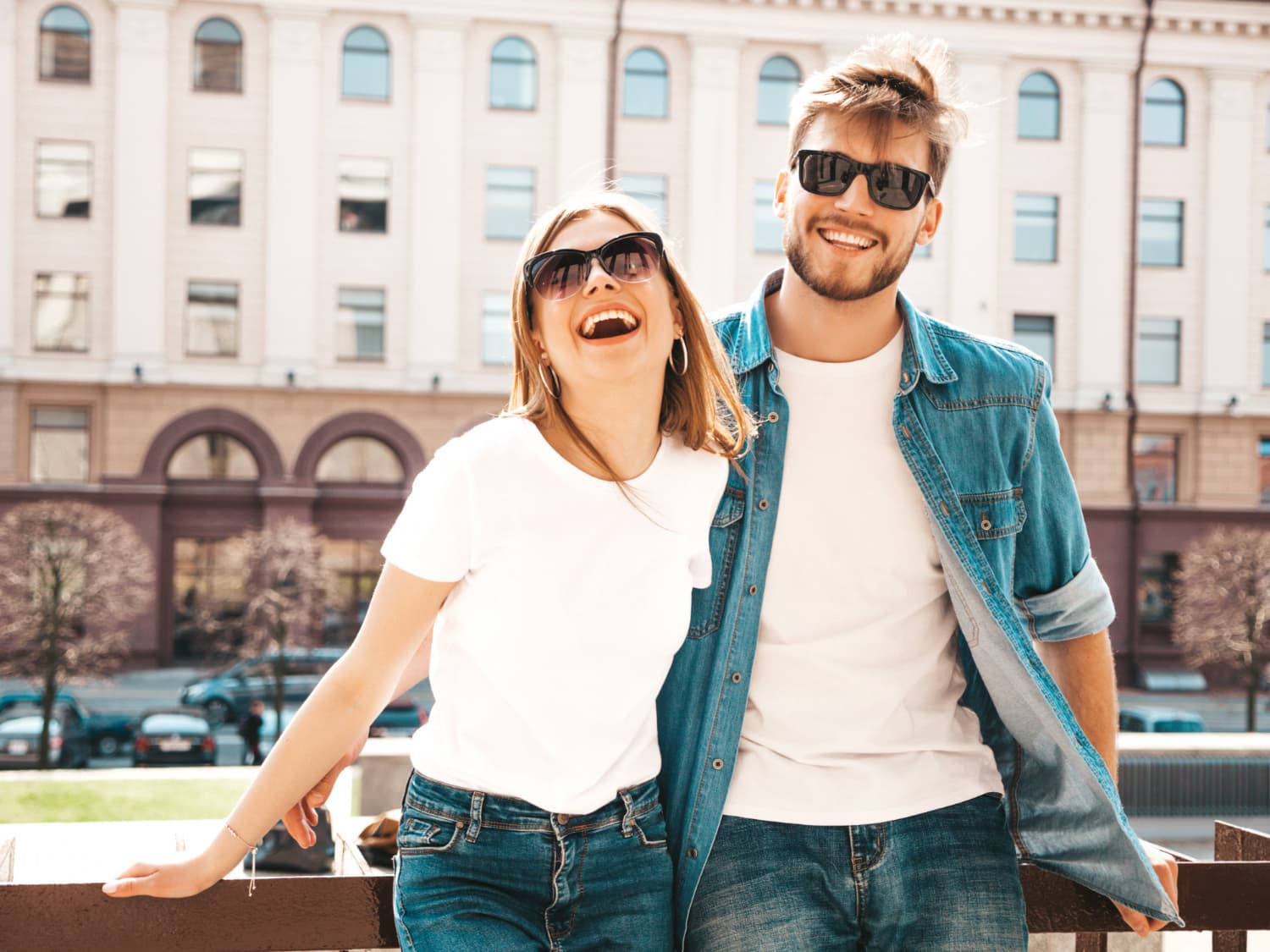 A couple laughing together outdoors in the city