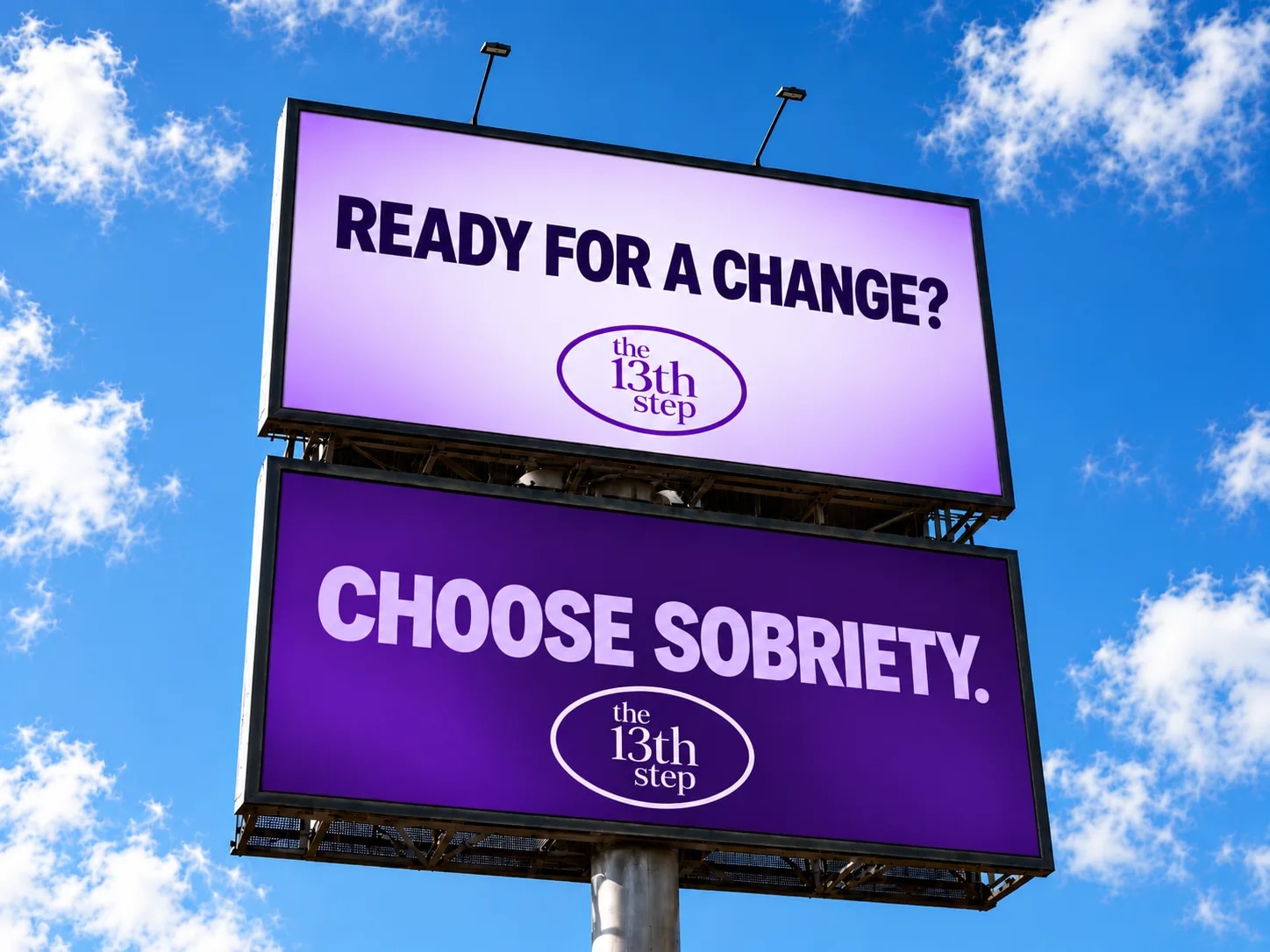 Outdoor billboard with two stacked signs. Top sign features light purple background with dark blue text reading 'READY FOR A CHANGE?' and the 13th Step logo in a purple oval. Bottom sign has deep purple background with light purple text reading 'CHOOSE SOBRIETY.' and the 13th Step logo in a white oval, against a bright blue sky with white clouds.